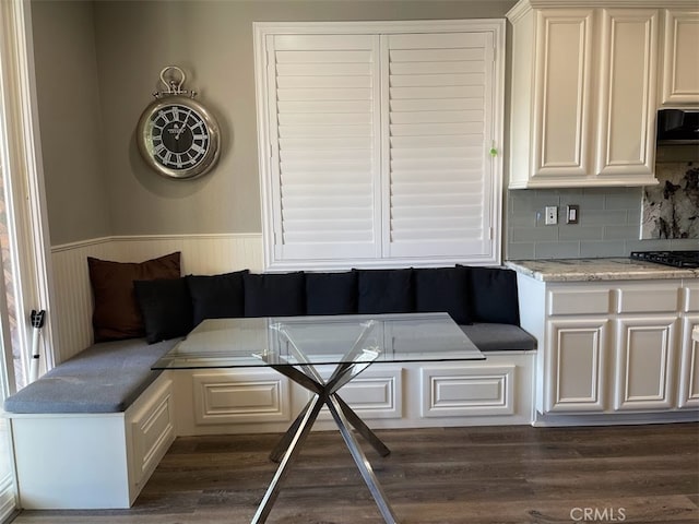 unfurnished dining area featuring dark hardwood / wood-style flooring and breakfast area