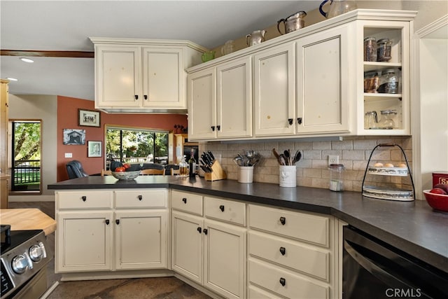 kitchen with decorative backsplash, appliances with stainless steel finishes, and kitchen peninsula