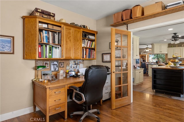 home office featuring hardwood / wood-style floors and ceiling fan