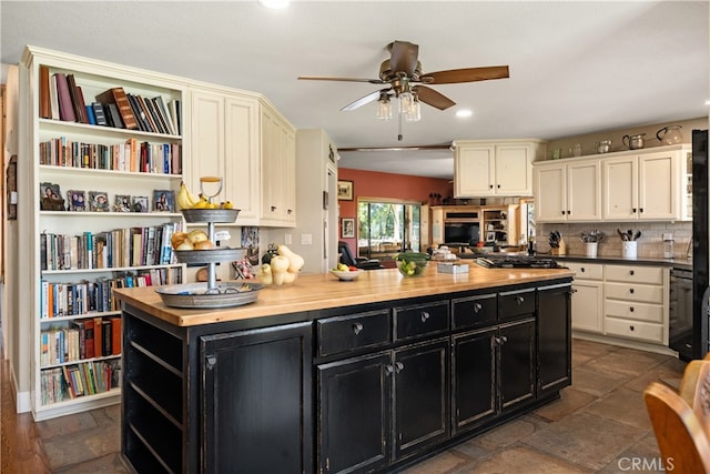 kitchen featuring tasteful backsplash, dishwasher, wood counters, a center island, and ceiling fan