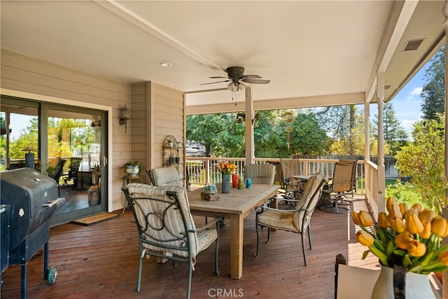 wooden deck featuring area for grilling and ceiling fan