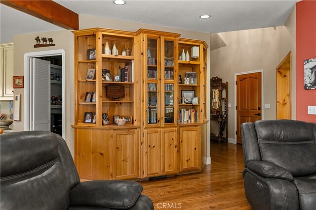 sitting room featuring beam ceiling and light wood-type flooring