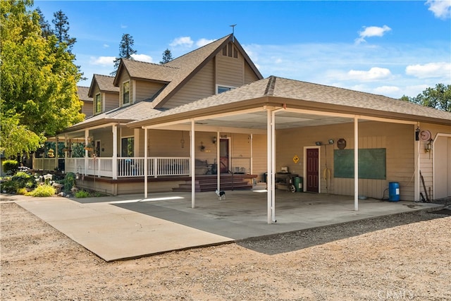 rear view of house featuring a porch