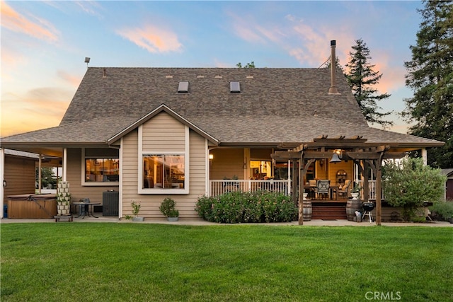 back house at dusk featuring a yard