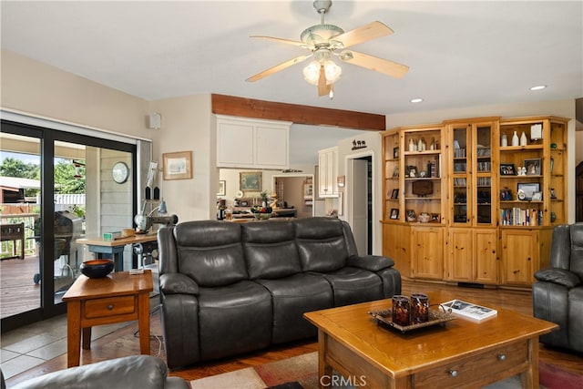 tiled living room featuring ceiling fan