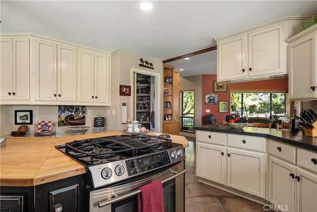 kitchen with cream cabinets and stainless steel gas stove