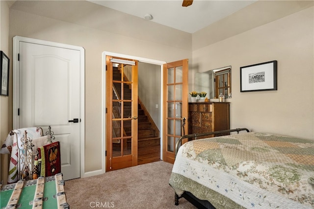 bedroom featuring french doors, ceiling fan, and carpet