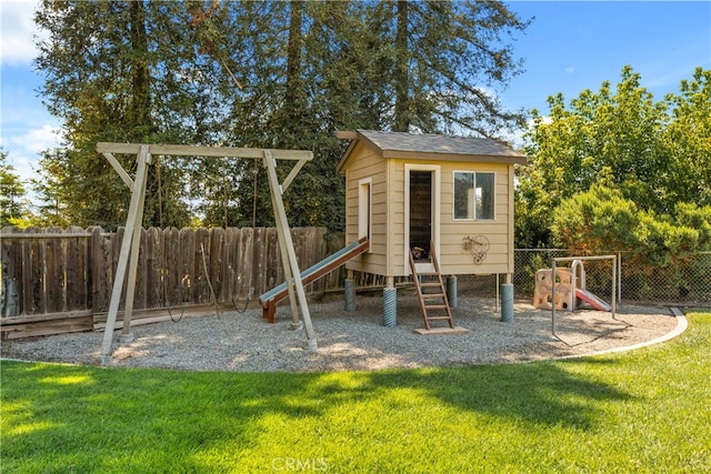 view of play area with an outdoor structure and a yard