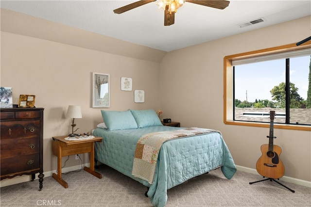 bedroom featuring ceiling fan, light carpet, and vaulted ceiling