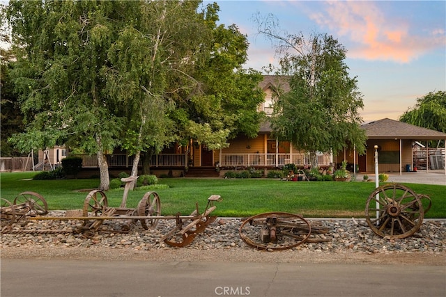 view of front facade with a yard and a porch