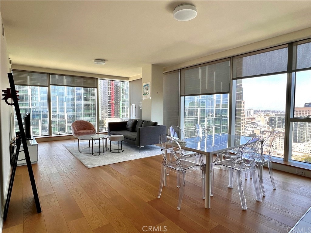 dining area featuring plenty of natural light, hardwood / wood-style floors, and expansive windows