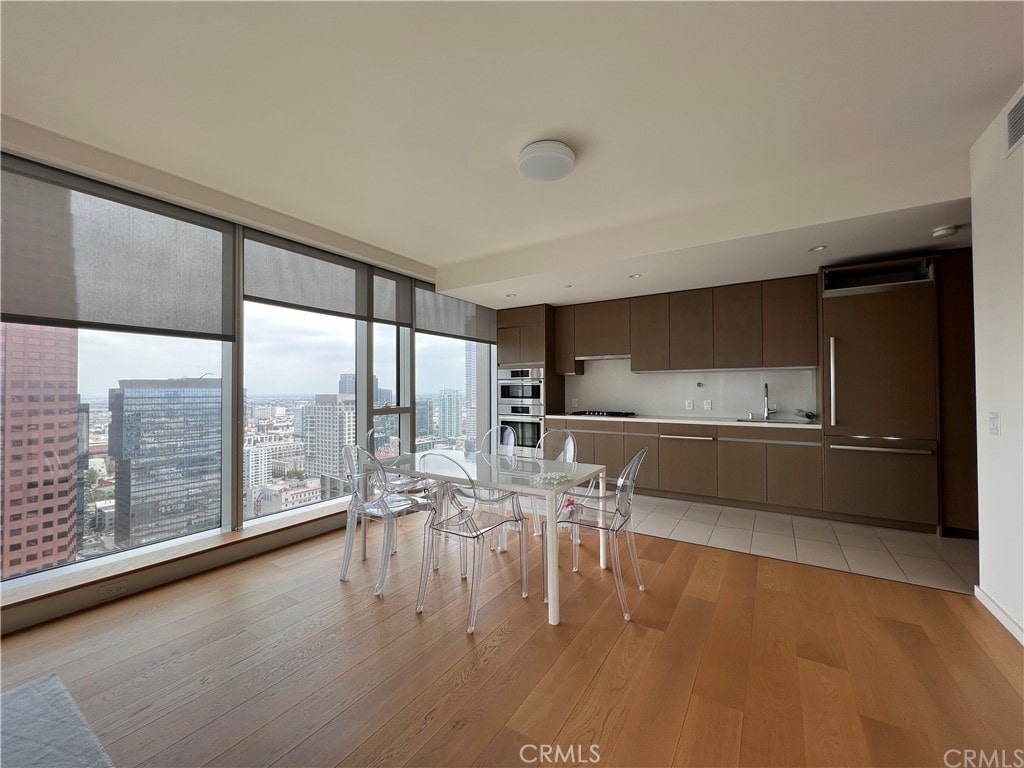 unfurnished dining area with light hardwood / wood-style floors and sink