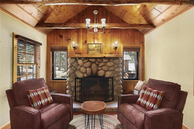 living room with vaulted ceiling with beams, wood ceiling, a fireplace, and a chandelier