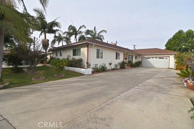 ranch-style house with a garage and a front lawn