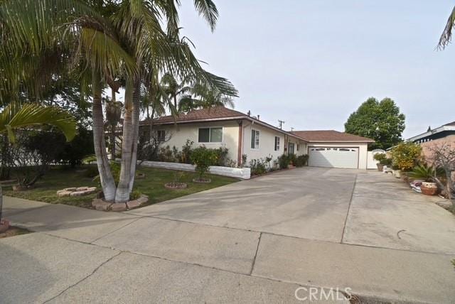 single story home featuring a front lawn and a garage