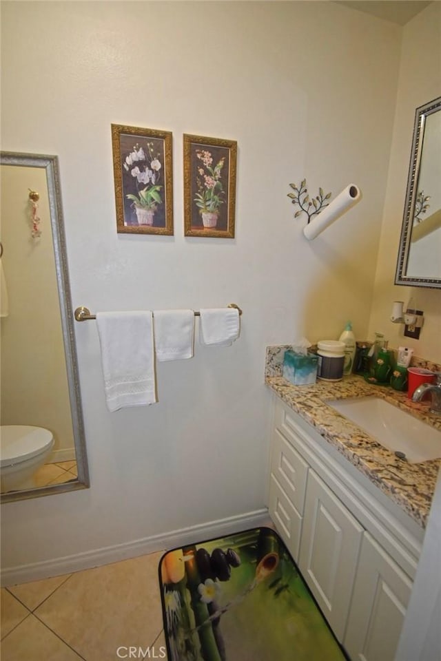 bathroom featuring tile patterned flooring and vanity