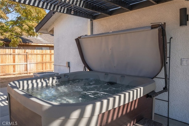 view of patio / terrace with a pergola and a hot tub