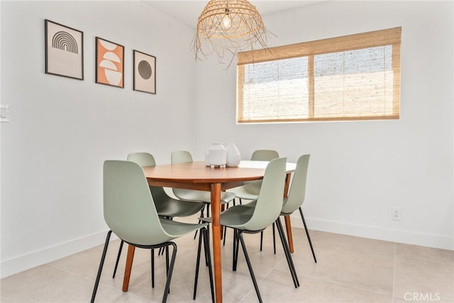 tiled dining room featuring a notable chandelier