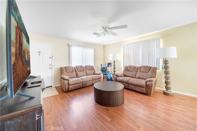 living room featuring hardwood / wood-style flooring and ceiling fan