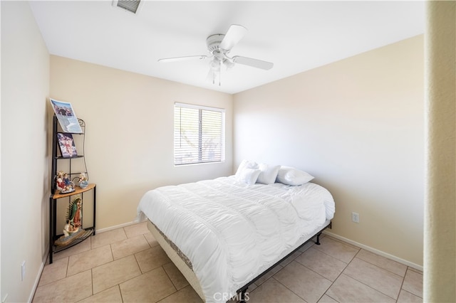 tiled bedroom with ceiling fan