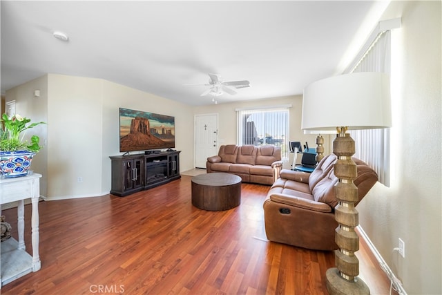 living room featuring wood-type flooring and ceiling fan