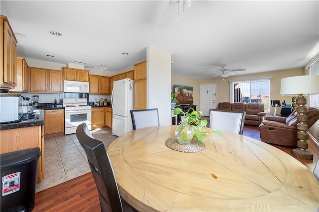 dining space featuring dark wood-type flooring and ceiling fan