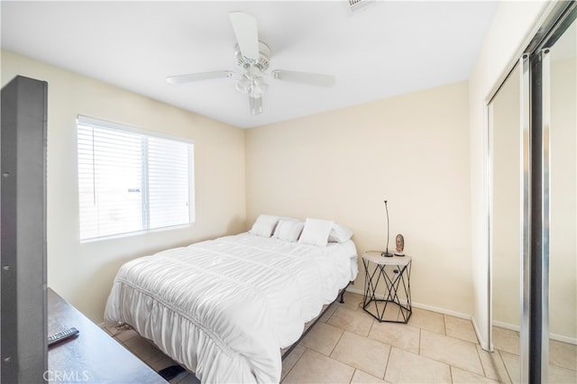 tiled bedroom with a closet and ceiling fan