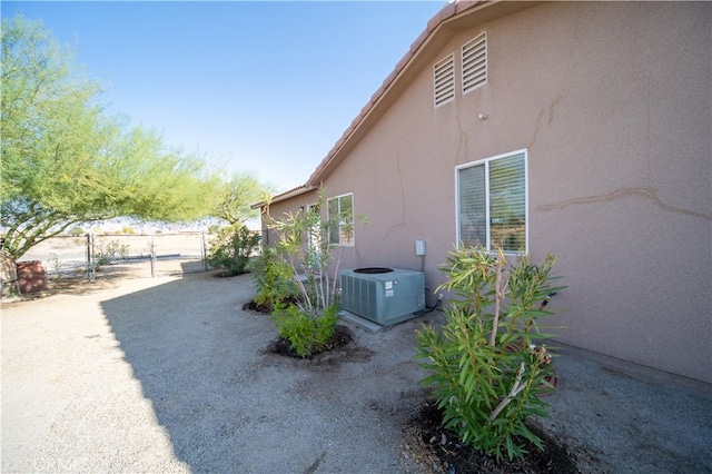 view of side of home featuring central AC