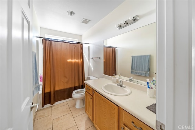 full bathroom featuring vanity, shower / bath combo with shower curtain, toilet, and tile patterned flooring