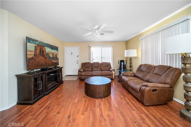 living room featuring ceiling fan and hardwood / wood-style floors