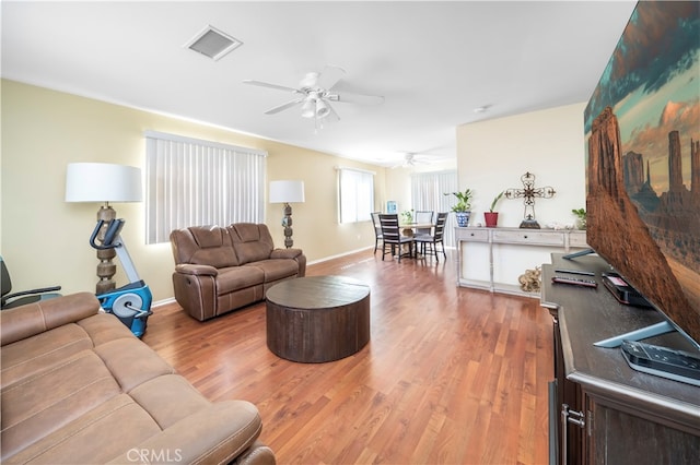 living room featuring ceiling fan and wood-type flooring