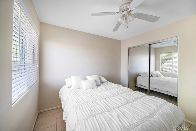 bedroom with a closet, ceiling fan, and tile patterned floors