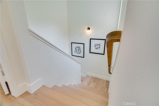 stairway with wood finished floors