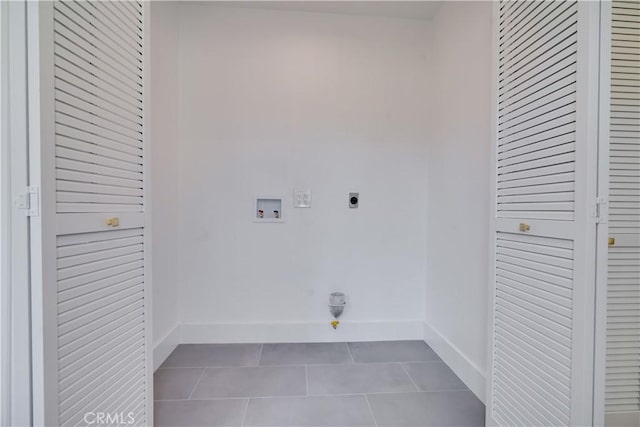 washroom featuring tile patterned floors, hookup for an electric dryer, baseboards, washer hookup, and laundry area