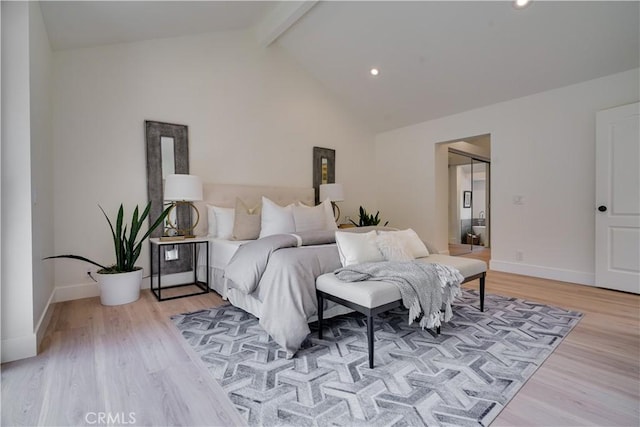 bedroom featuring recessed lighting, beam ceiling, and light wood finished floors