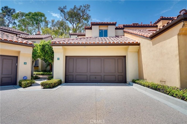 garage featuring concrete driveway