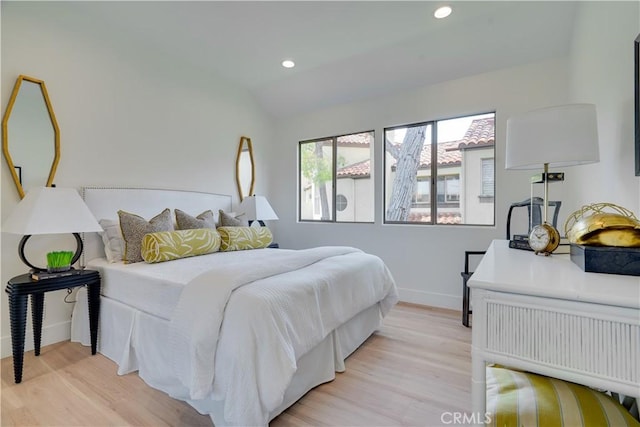 bedroom featuring recessed lighting, vaulted ceiling, light wood-type flooring, and baseboards