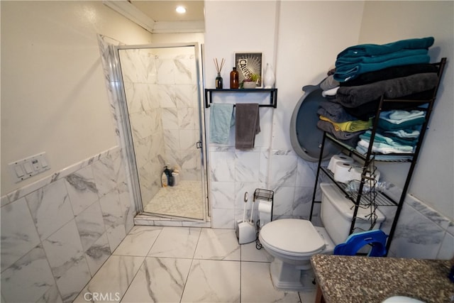 bathroom featuring a shower with door, toilet, tile walls, and vanity