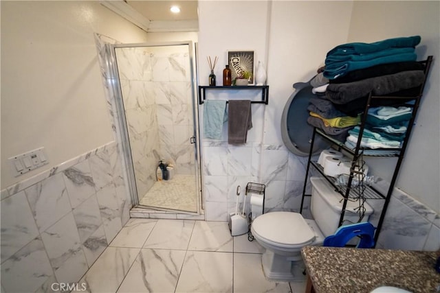 bathroom with tile walls, a shower stall, toilet, and marble finish floor