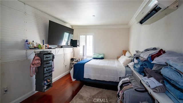 bedroom featuring ornamental molding, dark hardwood / wood-style flooring, and a wall mounted air conditioner