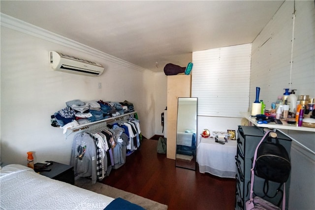 bedroom with ornamental molding, a wall mounted AC, and dark hardwood / wood-style flooring