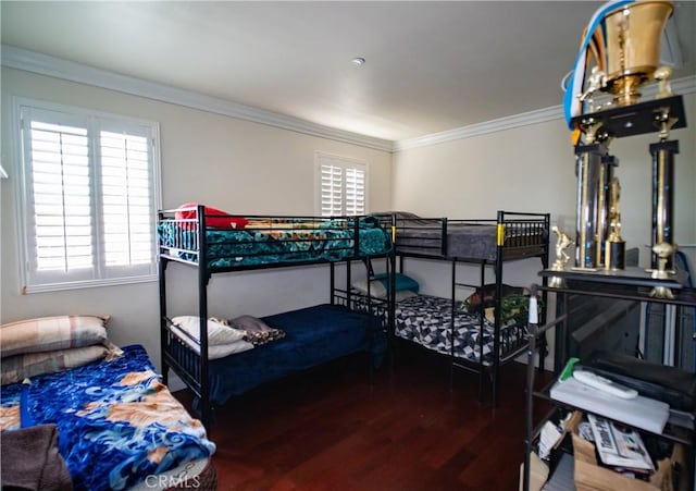 bedroom with crown molding and wood finished floors