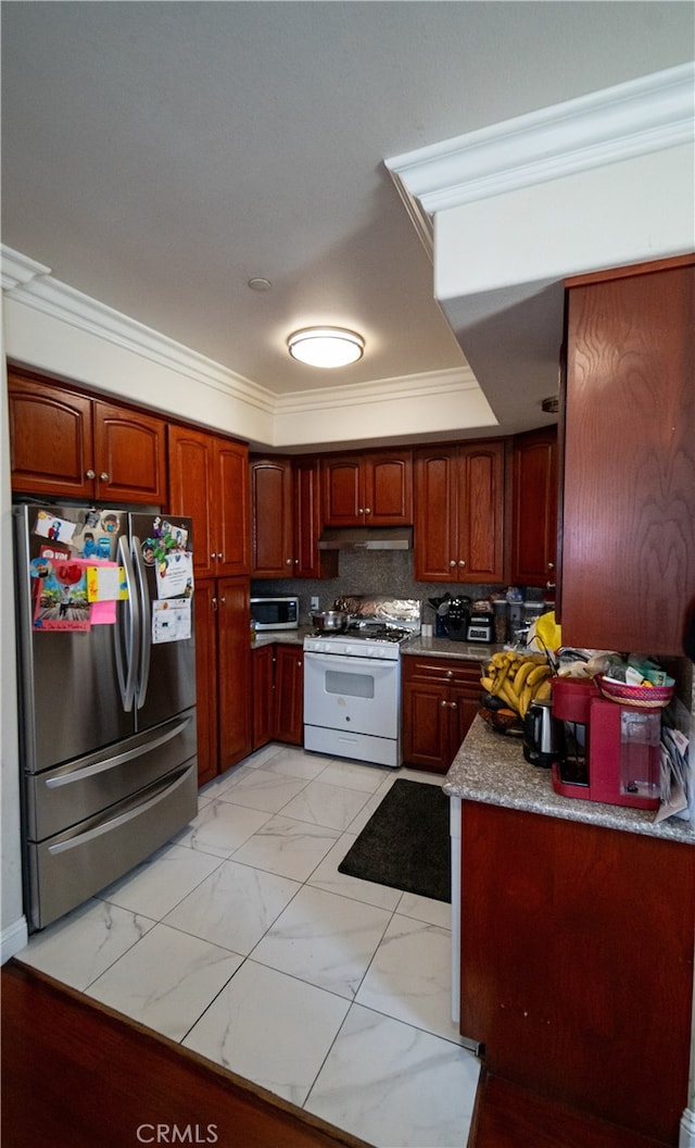 kitchen featuring backsplash, stainless steel refrigerator, white range with gas cooktop, and ornamental molding