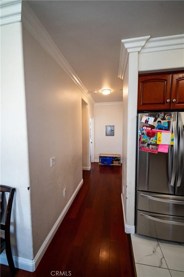 hall featuring crown molding, baseboards, and wood finished floors