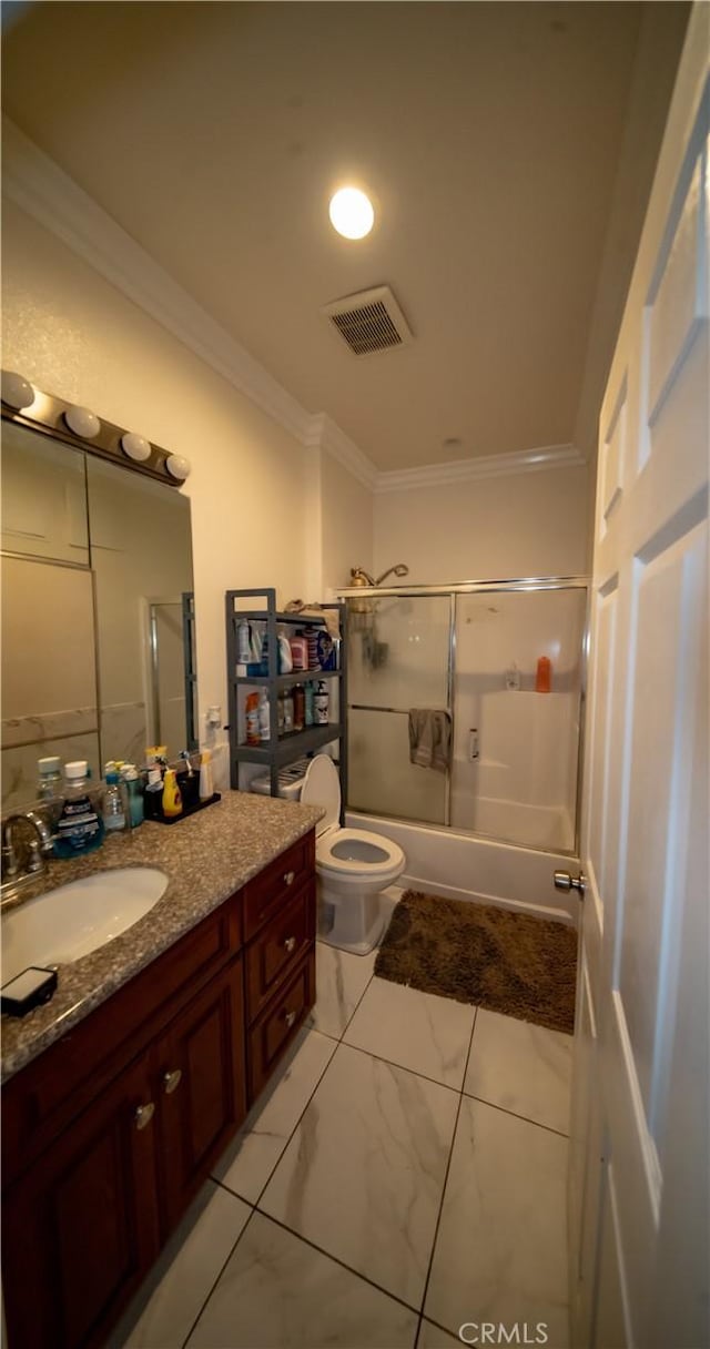bathroom with visible vents, vanity, combined bath / shower with glass door, toilet, and ornamental molding