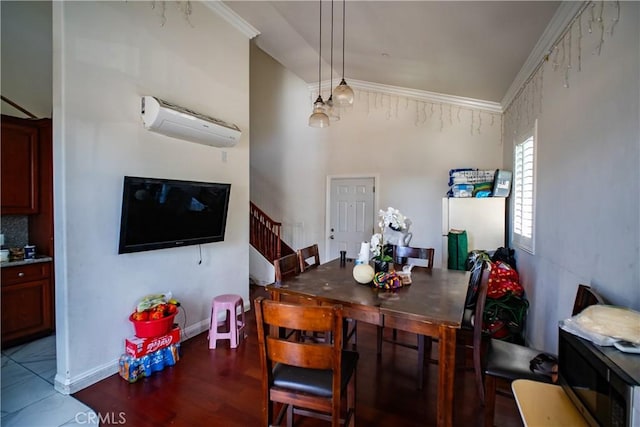 dining space featuring a wall mounted AC, wood finished floors, stairway, baseboards, and lofted ceiling