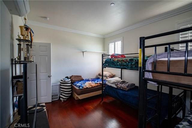 bedroom with crown molding and wood finished floors