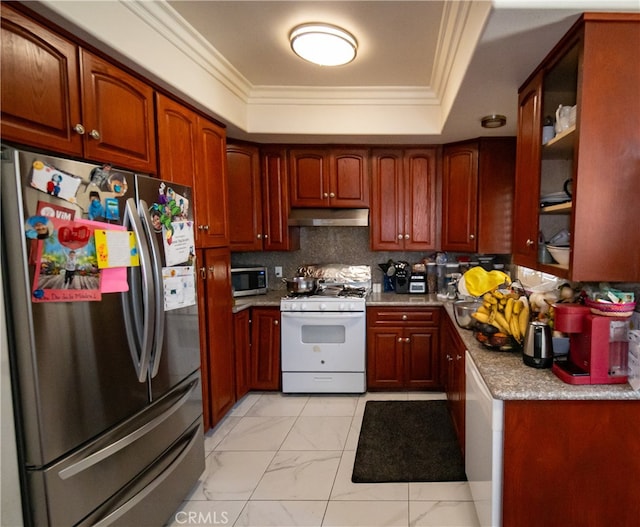 kitchen featuring crown molding, decorative backsplash, stainless steel appliances, and a tray ceiling