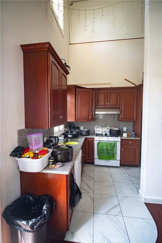 kitchen featuring decorative backsplash and white appliances