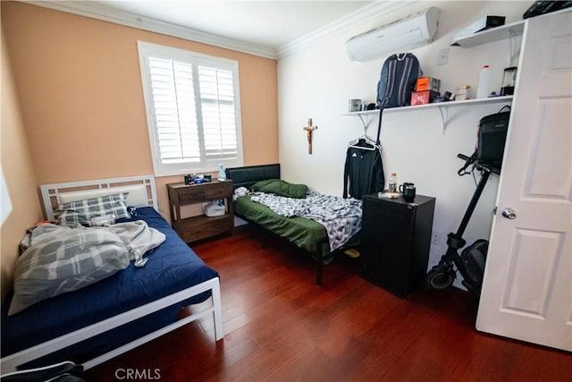 bedroom with crown molding, a wall mounted air conditioner, and wood finished floors